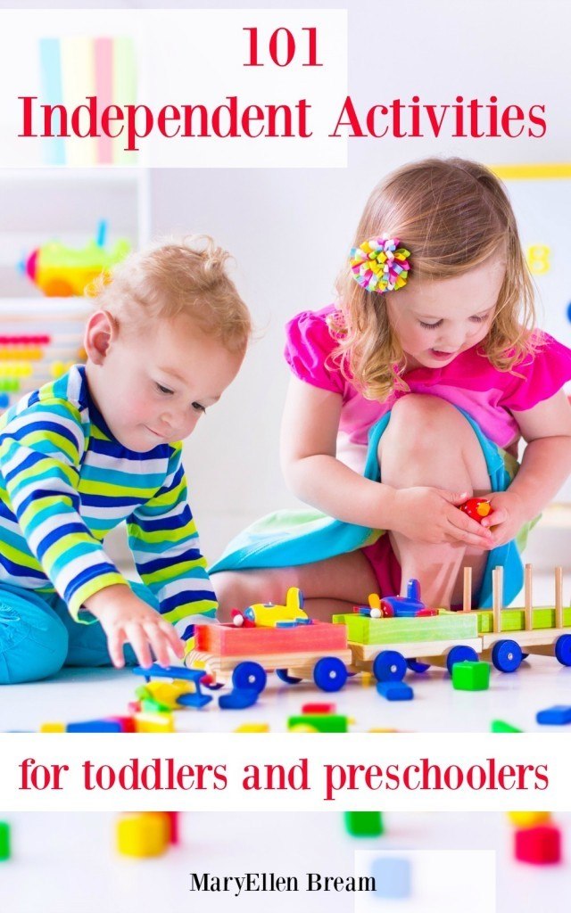 Kids play at day care. Two toddler children build tower of colorful wooden blocks. Child playing with toy train. Educational toys for preschool and kindergarten.