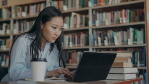 A woman looking for resources in the library.