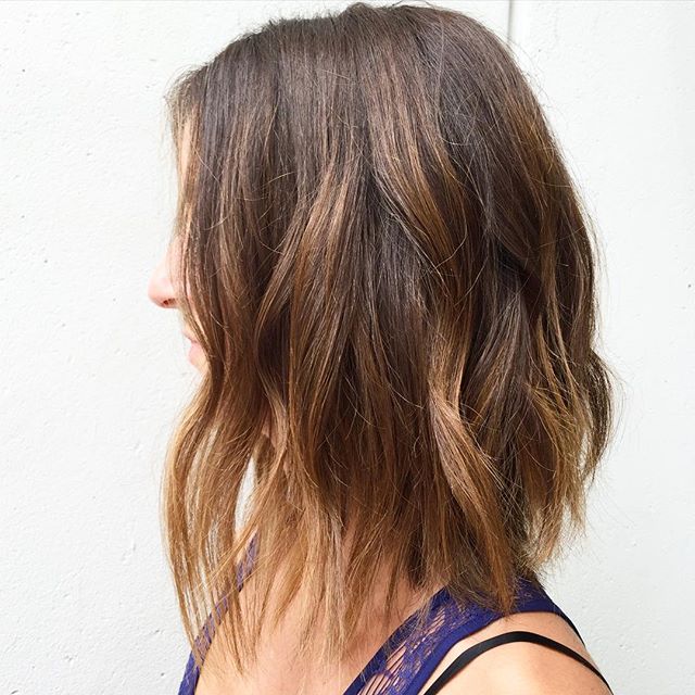 Medium length bob hairstyle with caramel balayage highlights